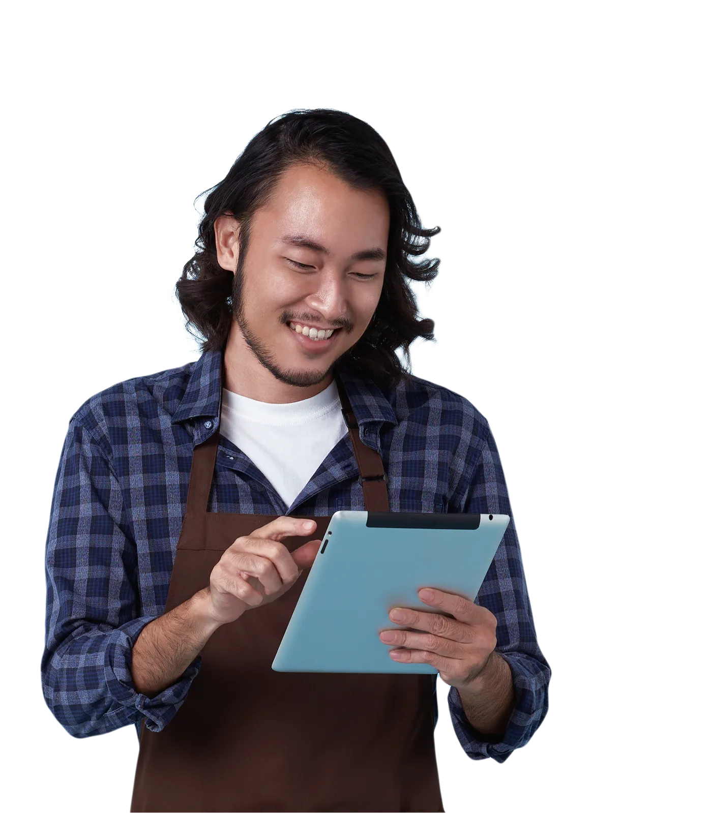 A smiling young entrepreneur wearing an apron using a tablet.
